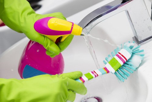 Technician using upholstery cleaning equipment on a chair